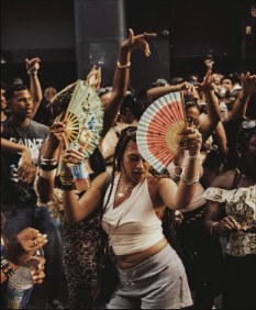 Crowd dancing with hand fans